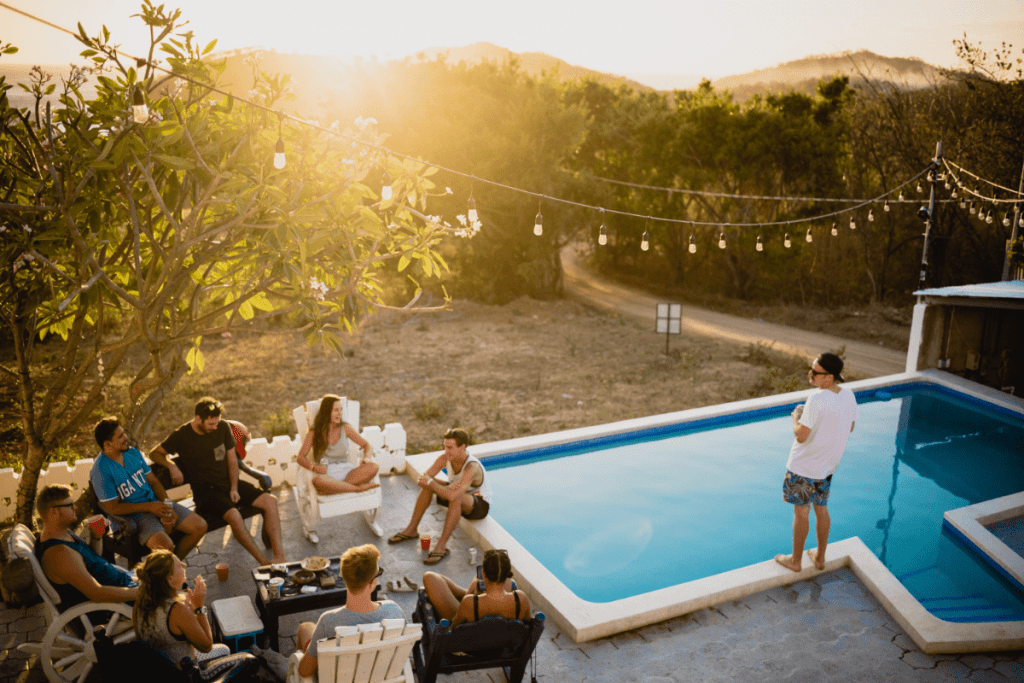 People sitting by the pool on a hot day.